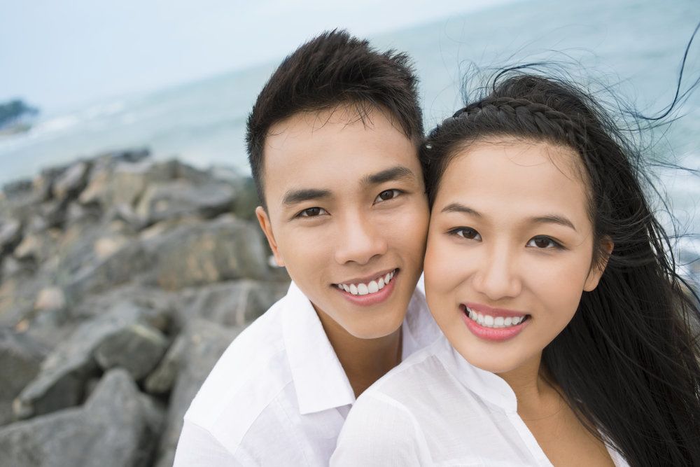 A young couple with beautiful smiles