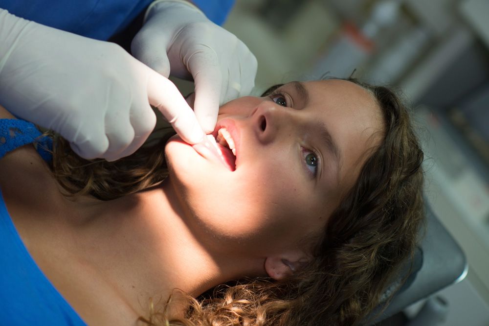 Woman undergoing oral cancer screening